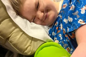 smiling girl in hospital bed