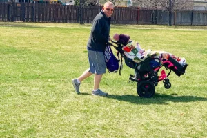 father pushing daughter in wheelchair